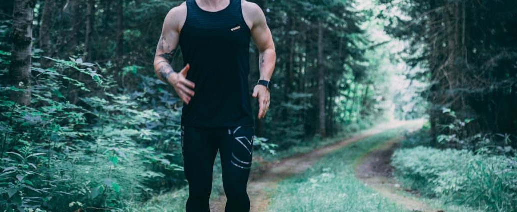 man walking on forest trail