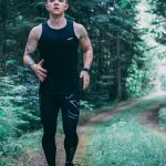 man walking on forest trail